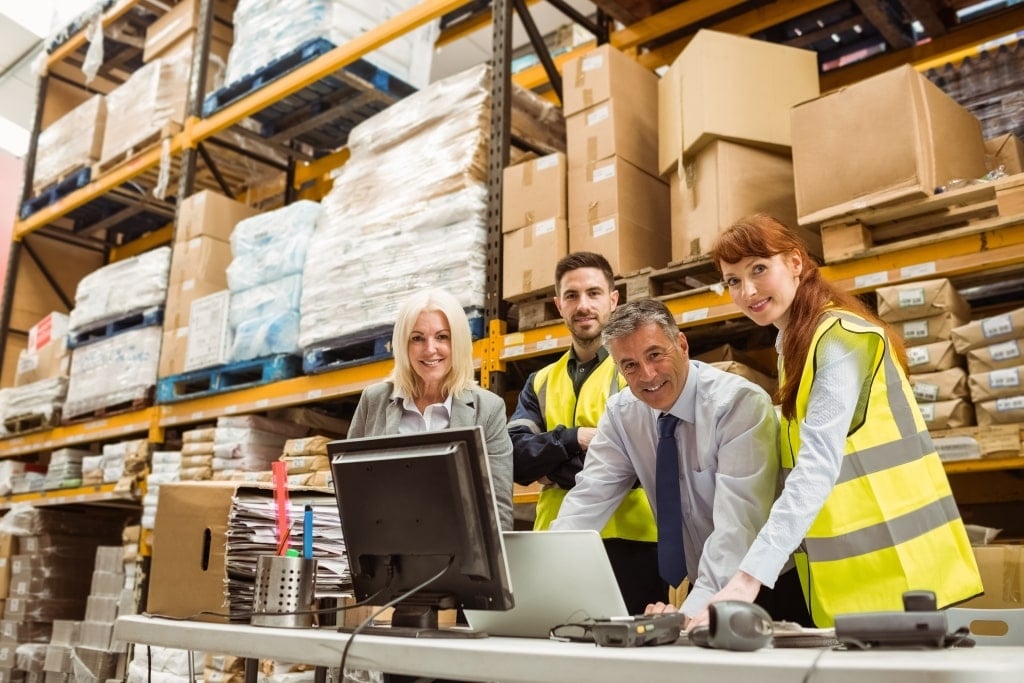 Warehouse team reviewing business operations for Passing on the Baton program at Baton Advisory